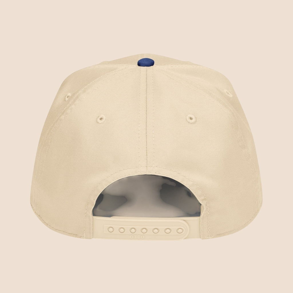 PUNJAB BOLDA beige 5 panel cap with adjustable snap closure and navy blue button on top. Made of polyester and cotton.