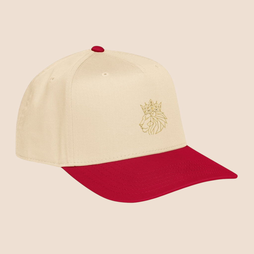 PUNJAB BOLDA beige 5 panel cap with red brim and embroidered crowned lion logo on front panel.