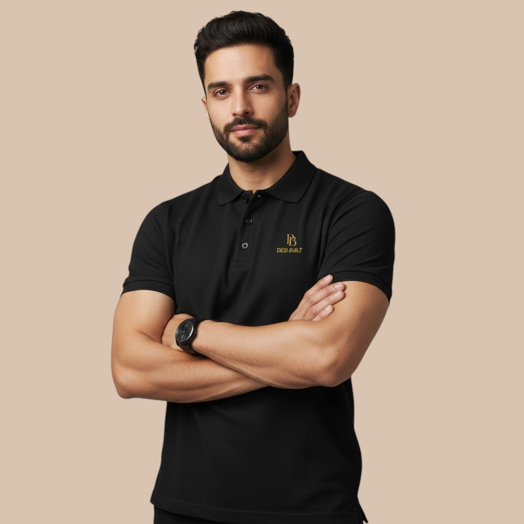 PUNJAB BOLDA black pique polo shirt with gold embroidered logo on chest, short sleeves, ribbed collar, and button placket.