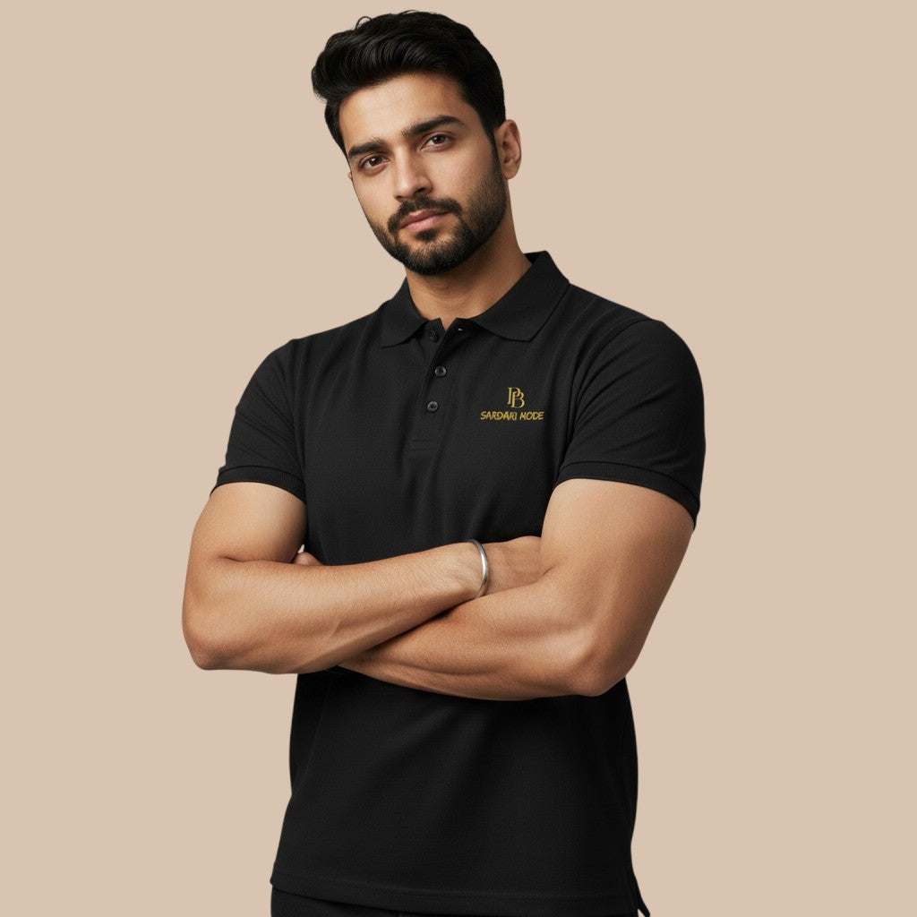 PUNJAB BOLDA black pique polo shirt with gold logo embroidery and ribbed collar. Classic fit, 100% cotton.