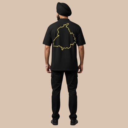 PUNJAB BOLDA black cotton t-shirt with yellow Punjab map outline on back. Model wears turban and cargo pants.