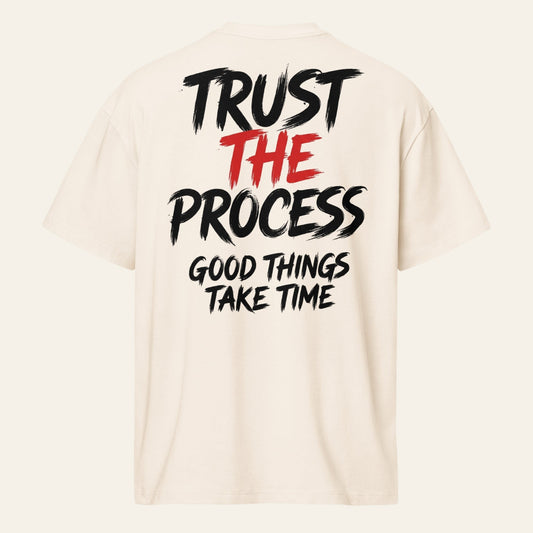 PUNJAB BOLDA cream oversized boxy tee with Trust The Process graphic print on the back in black and red text.