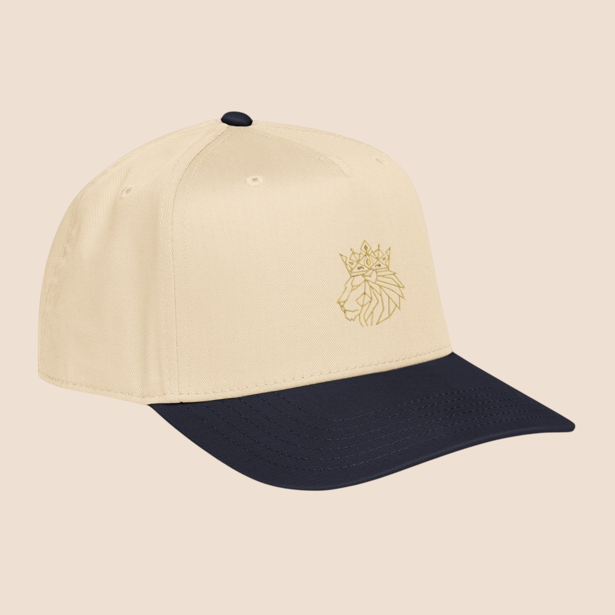 PUNJAB BOLDA crowned lion 5 panel cap in beige with navy brim and gold embroidered lion logo.