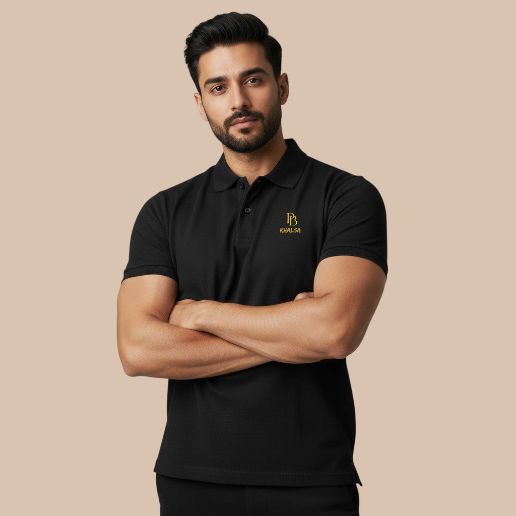 PUNJAB BOLDA KHALSA black pique polo shirt with gold logo, ribbed collar, and 3-button placket. 100% cotton.