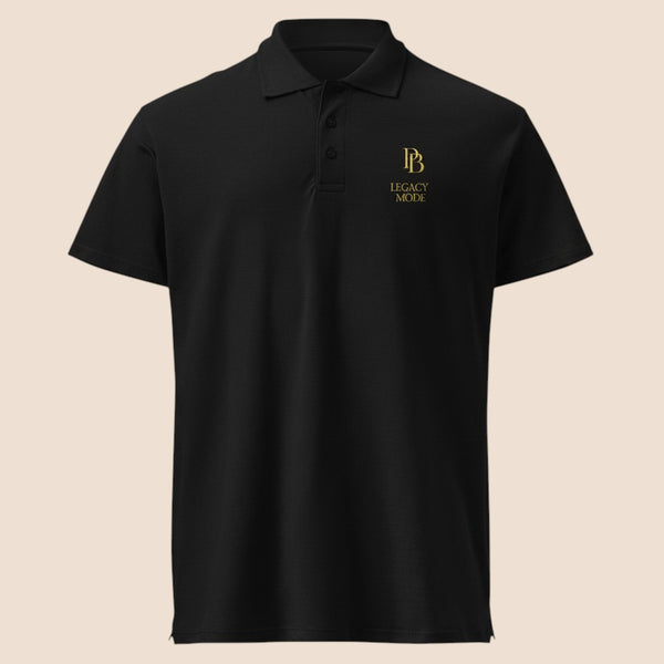 PUNJAB BOLDA black pique polo shirt with gold LEGACY MODE logo, featuring a 3-button placket and classic fit.