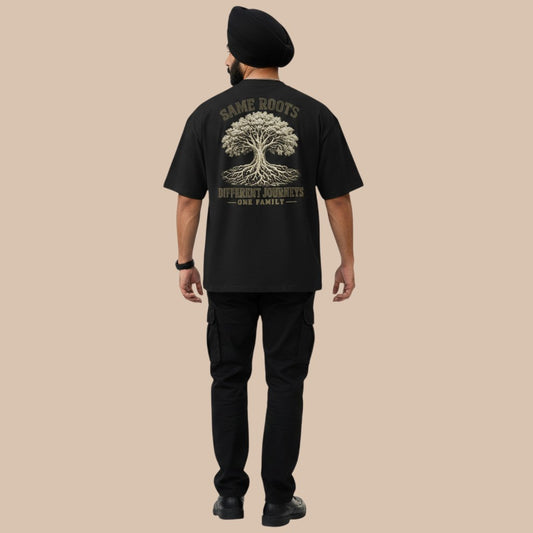 PUNJAB BOLDA black oversized t-shirt with graphic print of a tree and text "SAME ROOTS DIFFERENT JOURNEYS - ONE FAMILY".