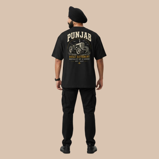 PUNJAB BOLDA black oversized t-shirt with graphic print of a tractor and text "BUILT DIFFERENT". 100% organic cotton.